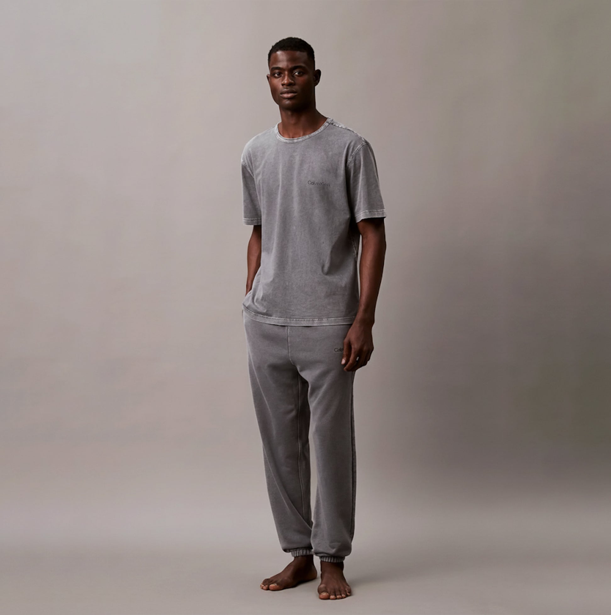 Calvin Klein 100% COTTON Mens Lounge T-Shirt Forged Iron front view on model, showing crew neckline and chest pocket.