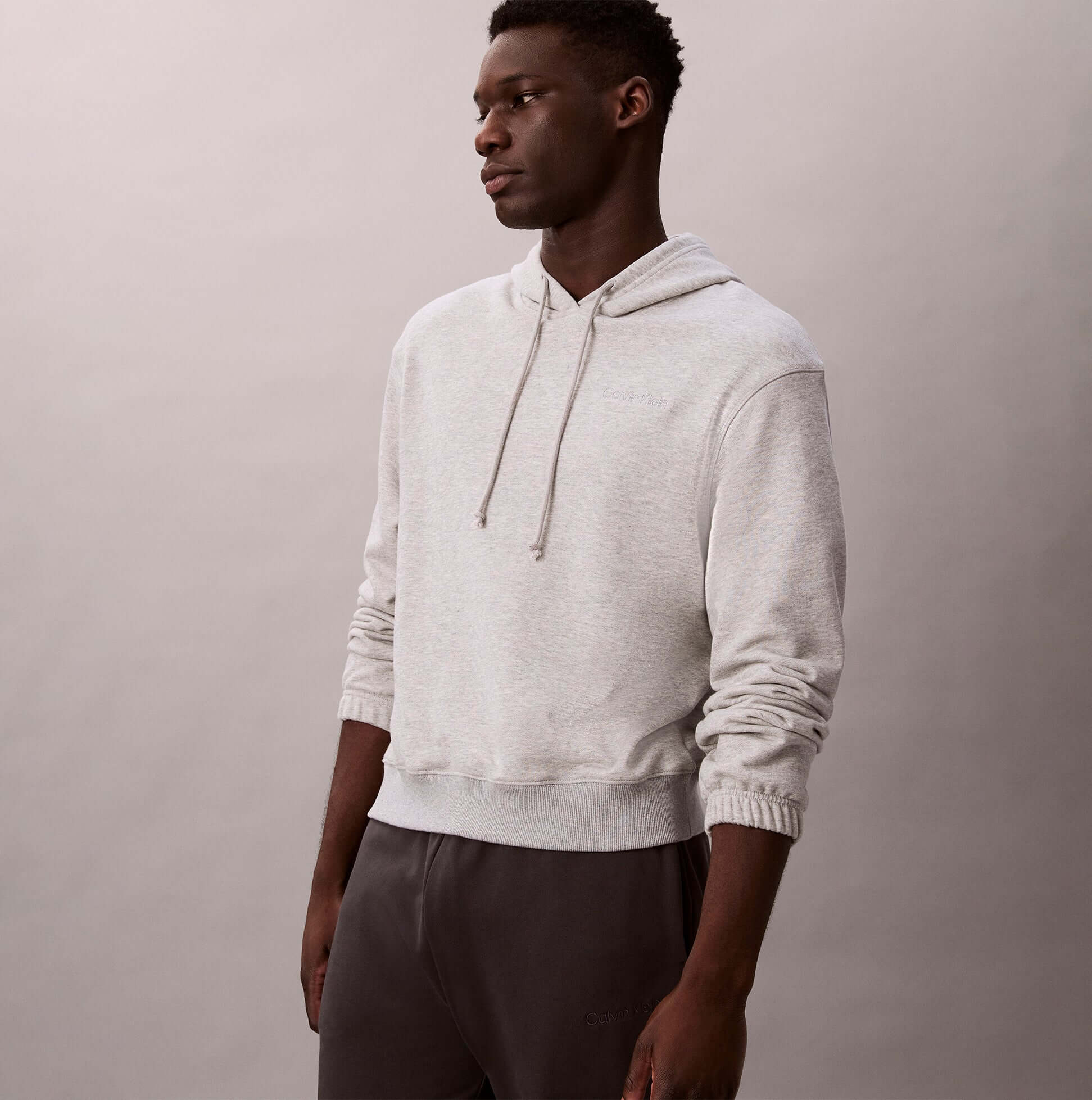 Calvin Klein L/S HOODIE Mens Hoodie Grey Heather side view on model in casual setting.