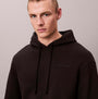 Calvin Klein L/S HOODIE Mens Hoodie Black front view, model wearing black relaxed hoodie, 85% cotton 15% polyester.