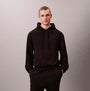 Calvin Klein L/S HOODIE Mens Hoodie Black front view with model wearing the hoodie, featuring relaxed fit and drawstring.