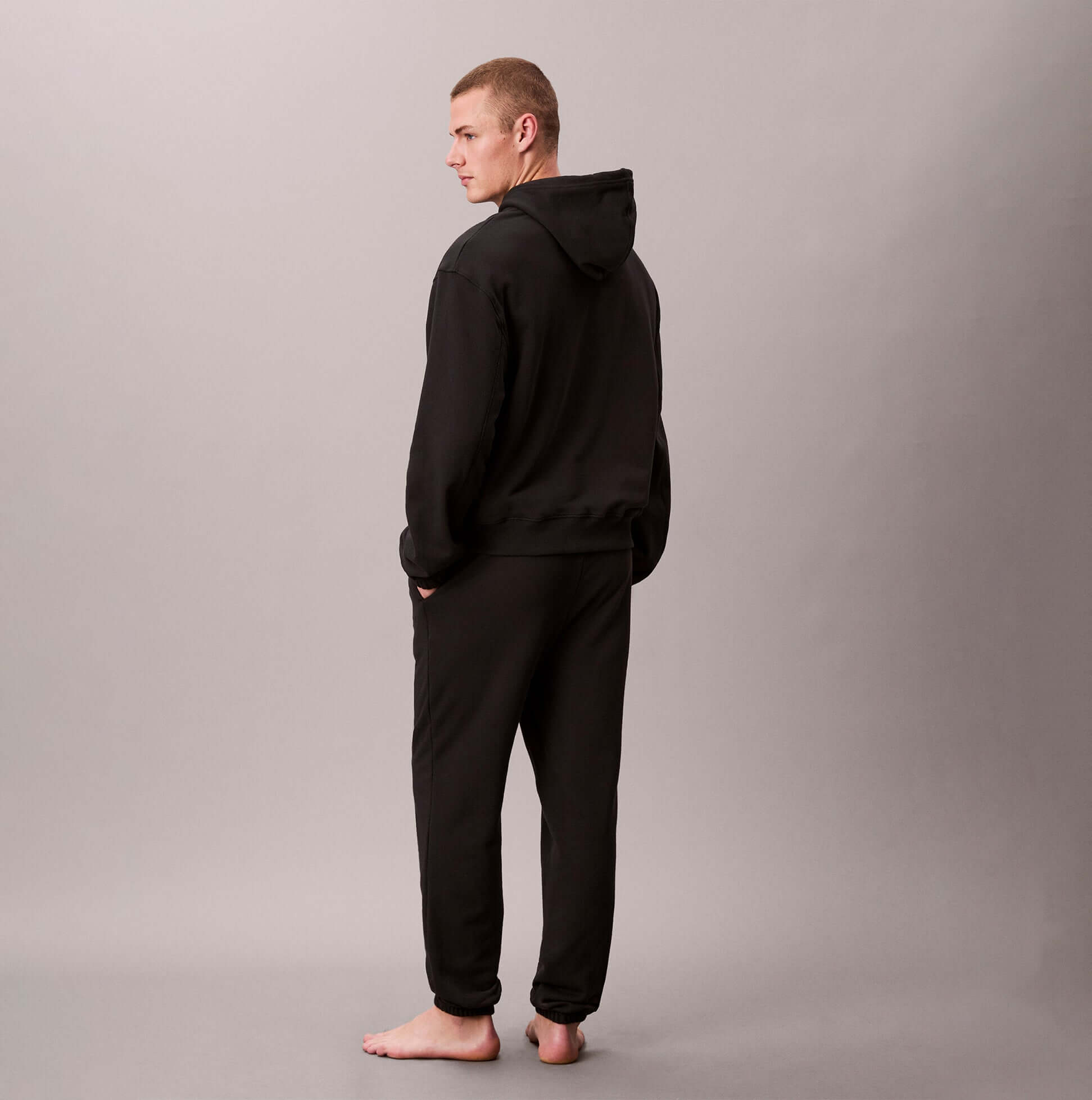 Calvin Klein JOGGER Mens Black back view with model wearing a black hoodie and joggers, showcasing the stylish design.