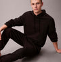 Calvin Klein JOGGER Mens Black front view, stylish black jogger outfit worn by a model sitting, comfortable casual wear.