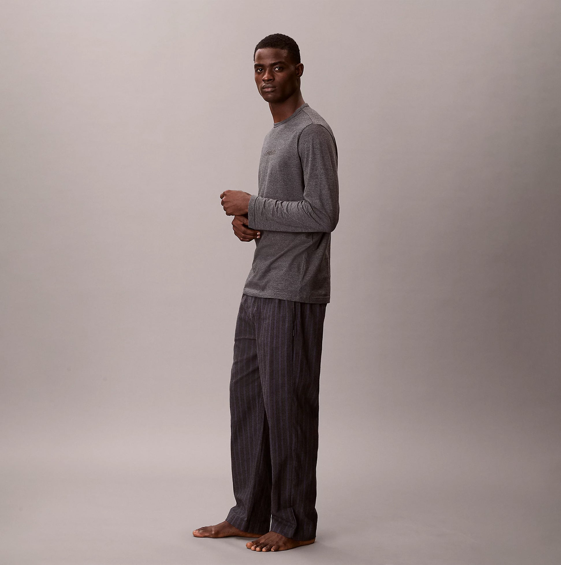 Calvin Klein LS TEE PANT SET Mens Multicoloured side view featuring a model in a long sleeve tee and striped pants.