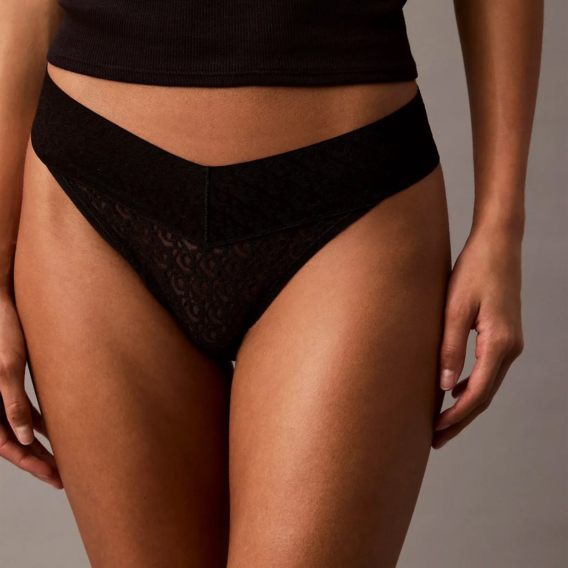 Calvin Klein THONG Womens Icon Logo Lace Molten Black front view showcasing lace design and black color.
