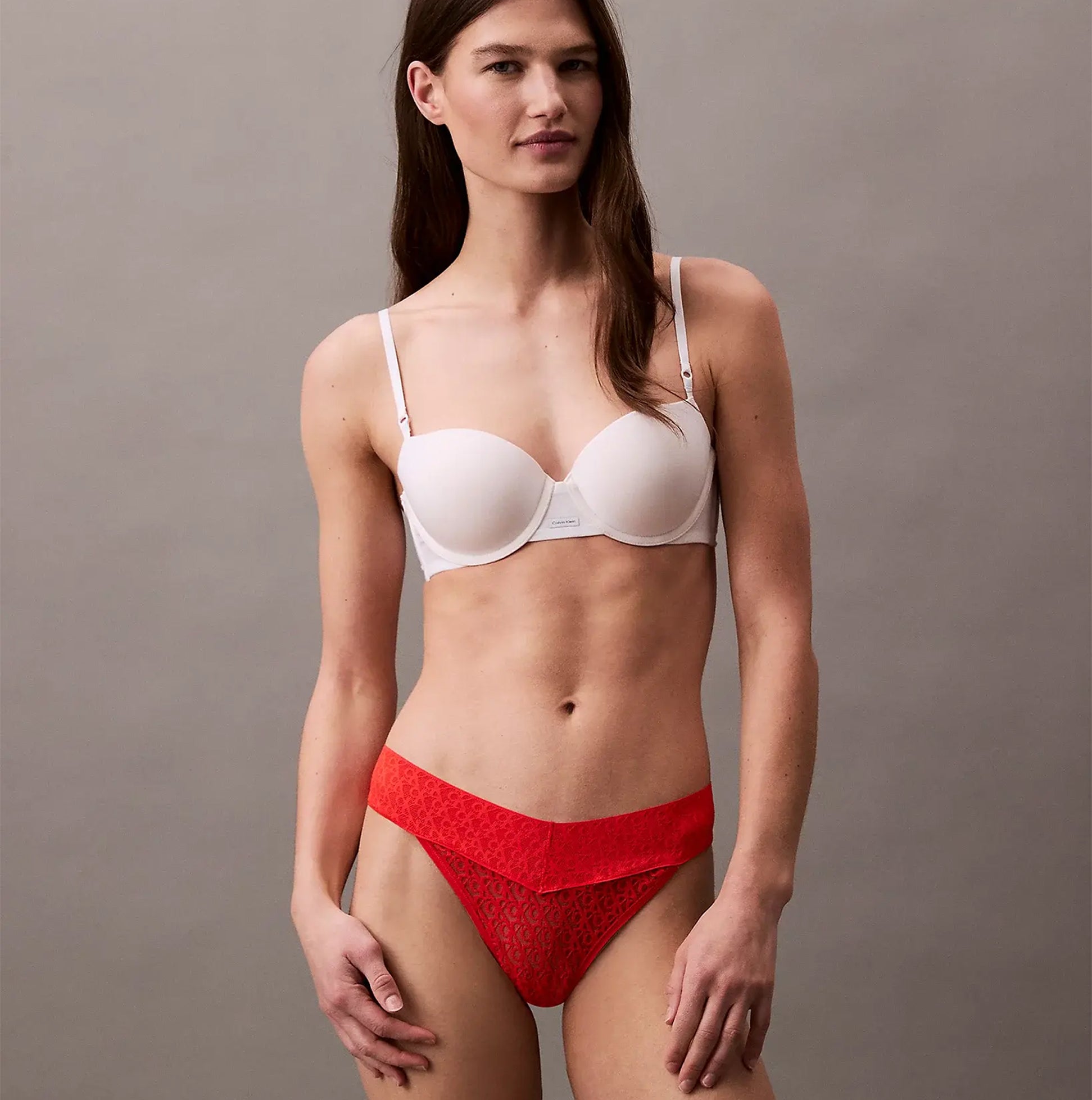 Calvin Klein THONG Womens Icon Logo Lace Molten Red front view on model, showcasing lace thong design with mixed colors.