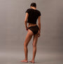 Calvin Klein ICON LOGO Low Rise Womens Bikini Briefs Black back view worn with a black crop top on model.
