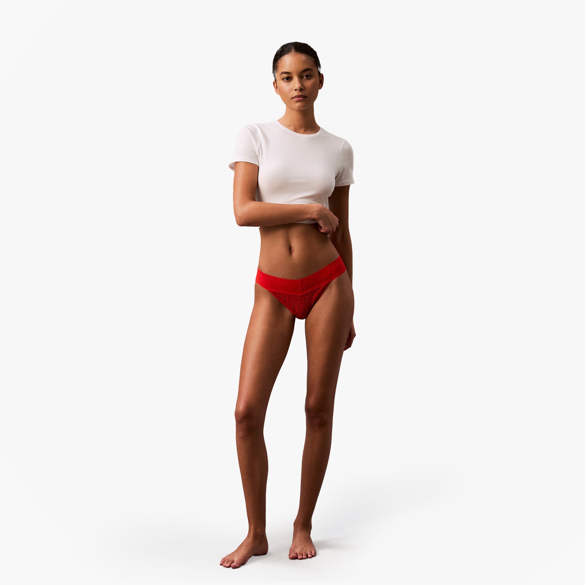 Calvin Klein ICON LOGO Low Rise Womens Bikini Briefs Molten worn by model in front view with a white shirt.