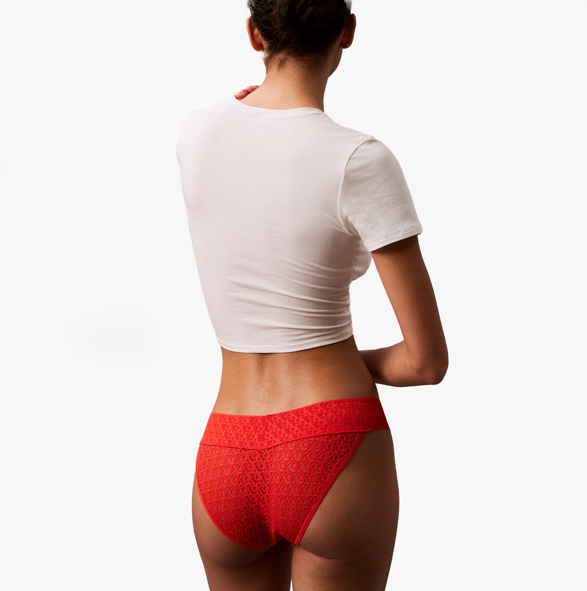 Calvin Klein ICON LOGO Low Rise Womens Bikini Briefs Molten rear view on model wearing white crop top.