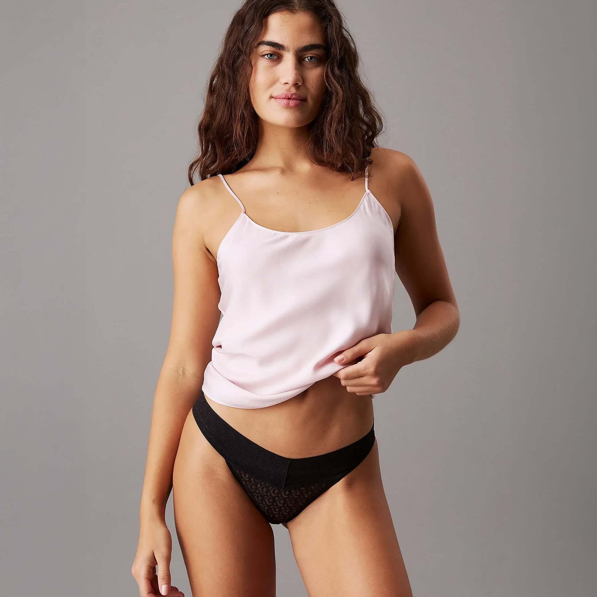 Calvin Klein ICON LOGO LACE 3 Pack Womens Bikini Briefs Black/White/Molten side view model wearing black bikini briefs and pink top.