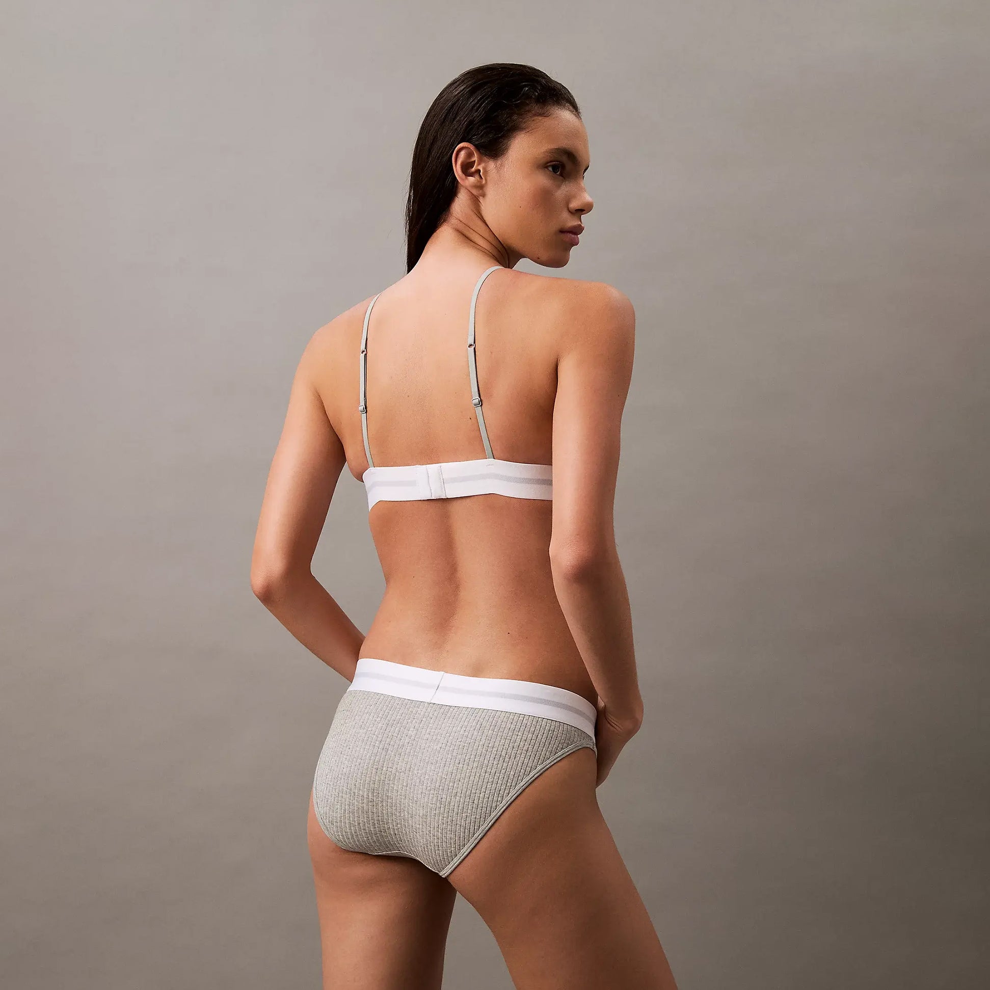 Calvin Klein BIKINI Brief Womens Cotton Modal Stretch Rib Grey rear view on model showcasing soft fabric and comfortable fit.