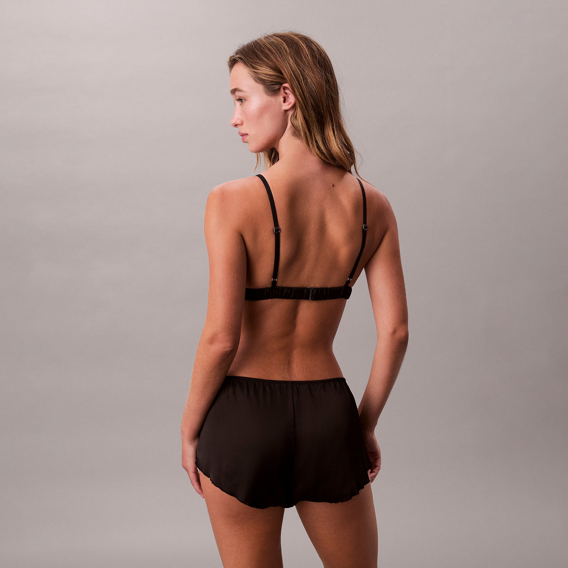 Calvin Klein UNLINED TRIANGLE Womens Black, back view showing the triangle bra and shorts in elegant black fabric.