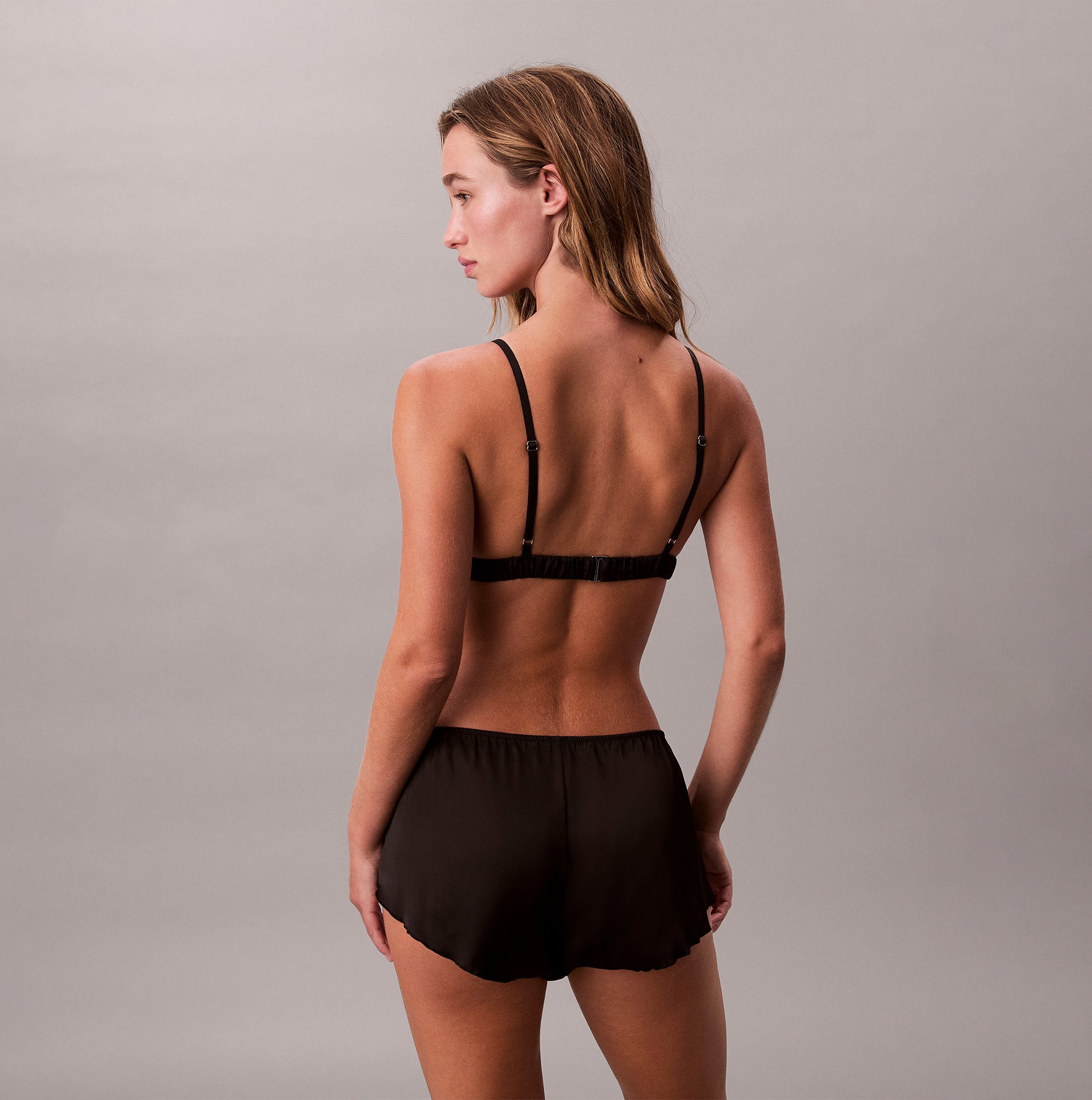 Calvin Klein UNLINED TRIANGLE Womens Black, back view showing the triangle bra and shorts in elegant black fabric.