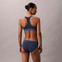 Calvin Klein Icon Cotton Modal Womens Unlined Bralette Denim back view on model, showcasing soft fabric and sporty design.