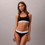 Calvin Klein Icon Cotton Modal Womens Unlined Bralette Black front view on model, featuring logo band and fitted design.
