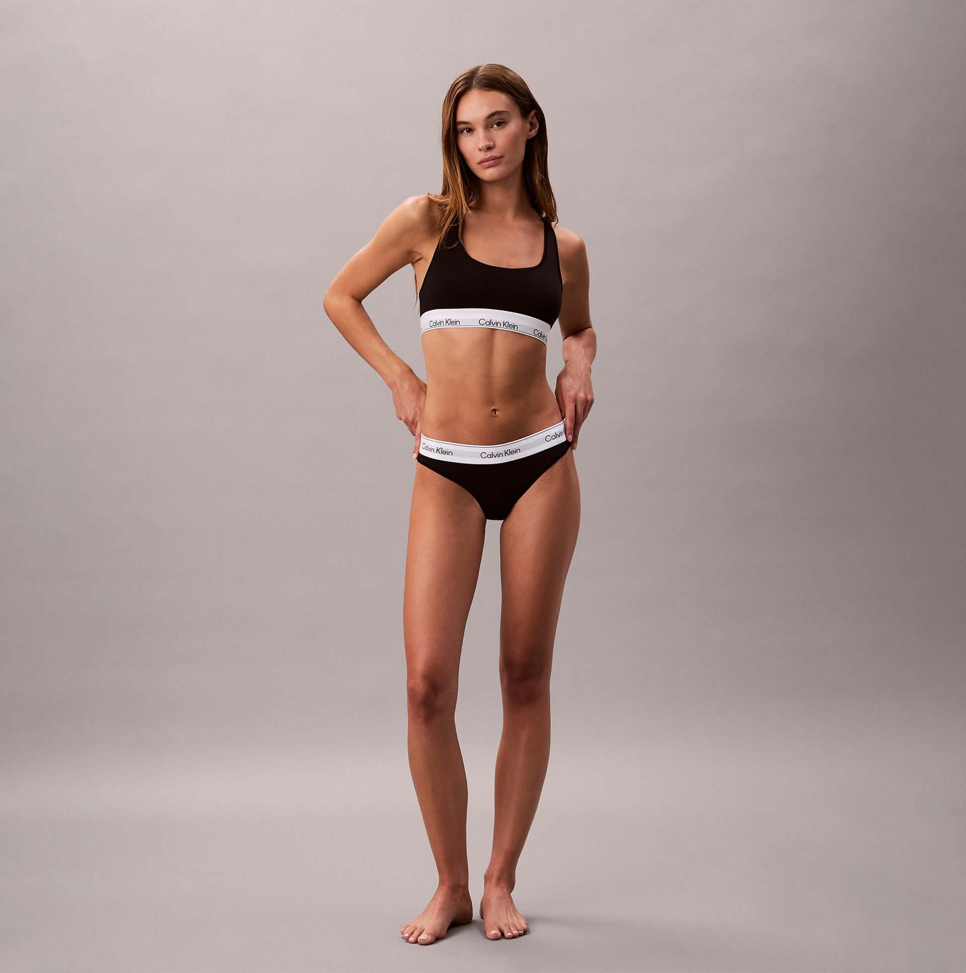 Calvin Klein Icon Cotton Modal Womens Unlined Bralette Black front view, showing model wearing matching black bralette and underwear.