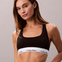 Calvin Klein Icon Cotton Modal Womens Unlined Bralette Black front view on model, featuring the signature logo band.