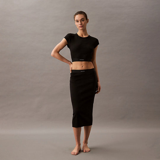 Calvin Klein COTTON STRETCH RIB Womens Crop Top Black front view on model with matching skirt and bare feet.