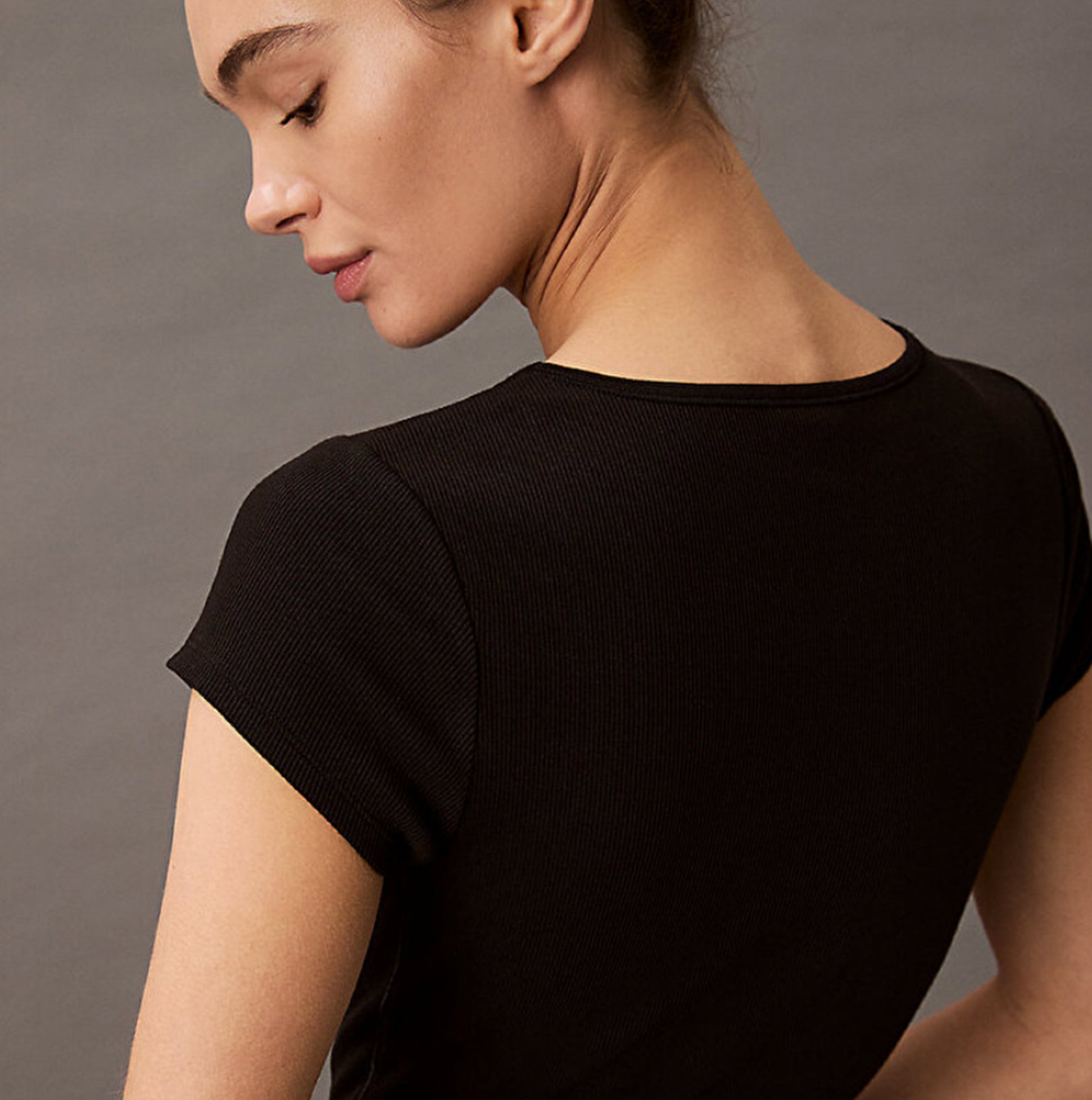Calvin Klein COTTON STRETCH RIB Womens Crop Top Black back view showing fine ribbed texture and short sleeves.