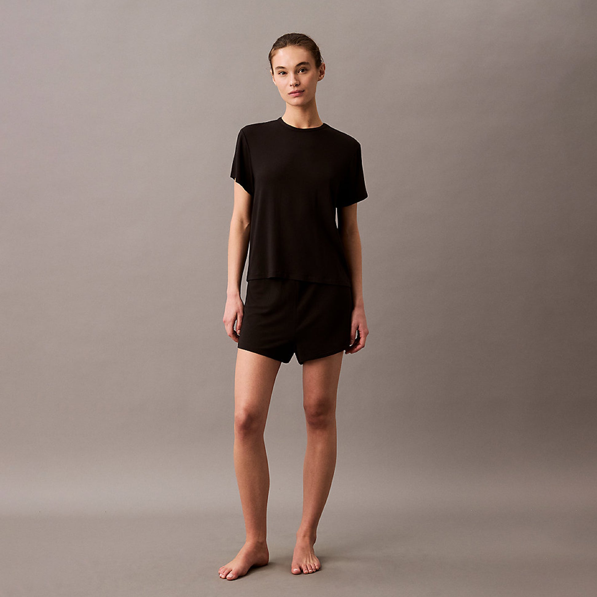 Calvin Klein ULTRA SOFT MODAL Womens Lounge T-Shirt Black front view on model, showcasing relaxed fit and short sleeves.