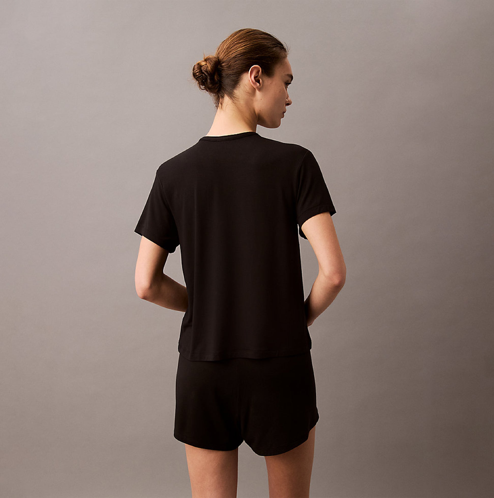 Calvin Klein ULTRA SOFT MODAL Womens Lounge T-Shirt Black back view model wearing short sleeves, relaxed fit, comfortable material.