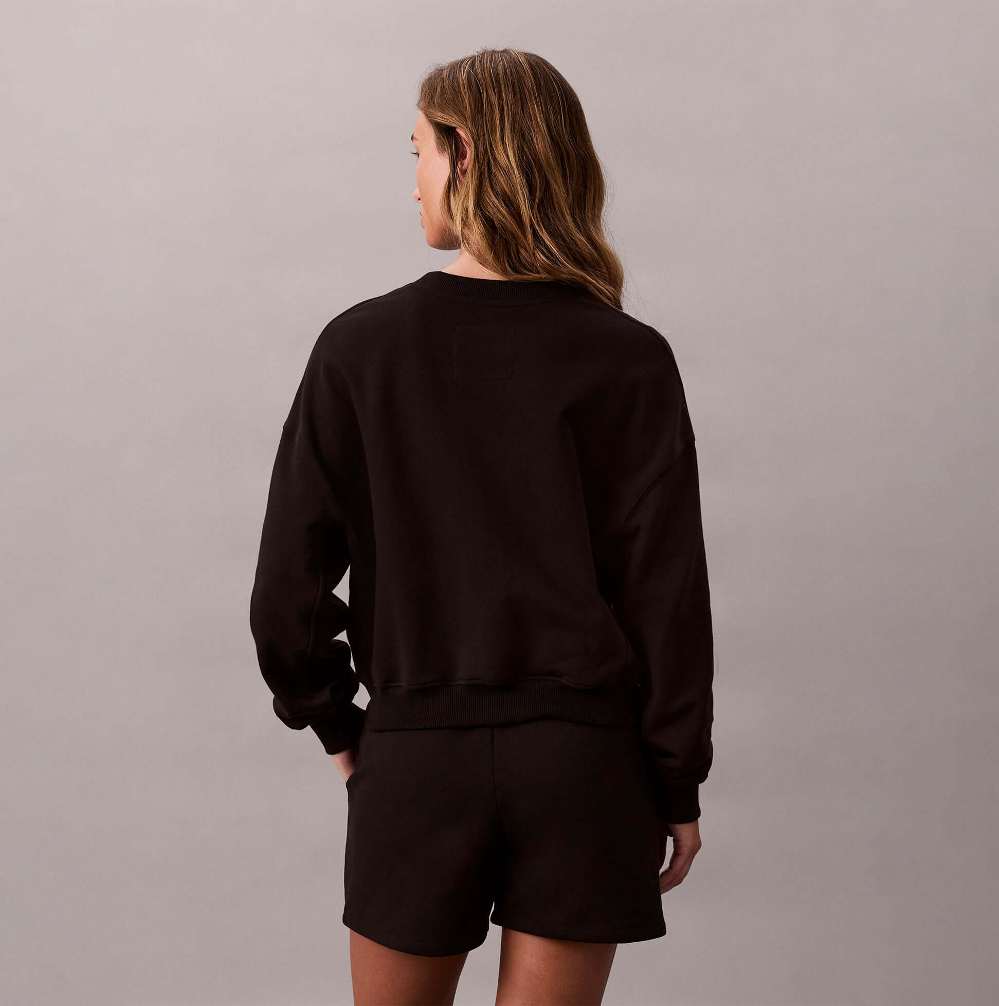 Calvin Klein Womens Long Sleeve Pyjama Top Black back view, showcasing the relaxed fit and casual style.