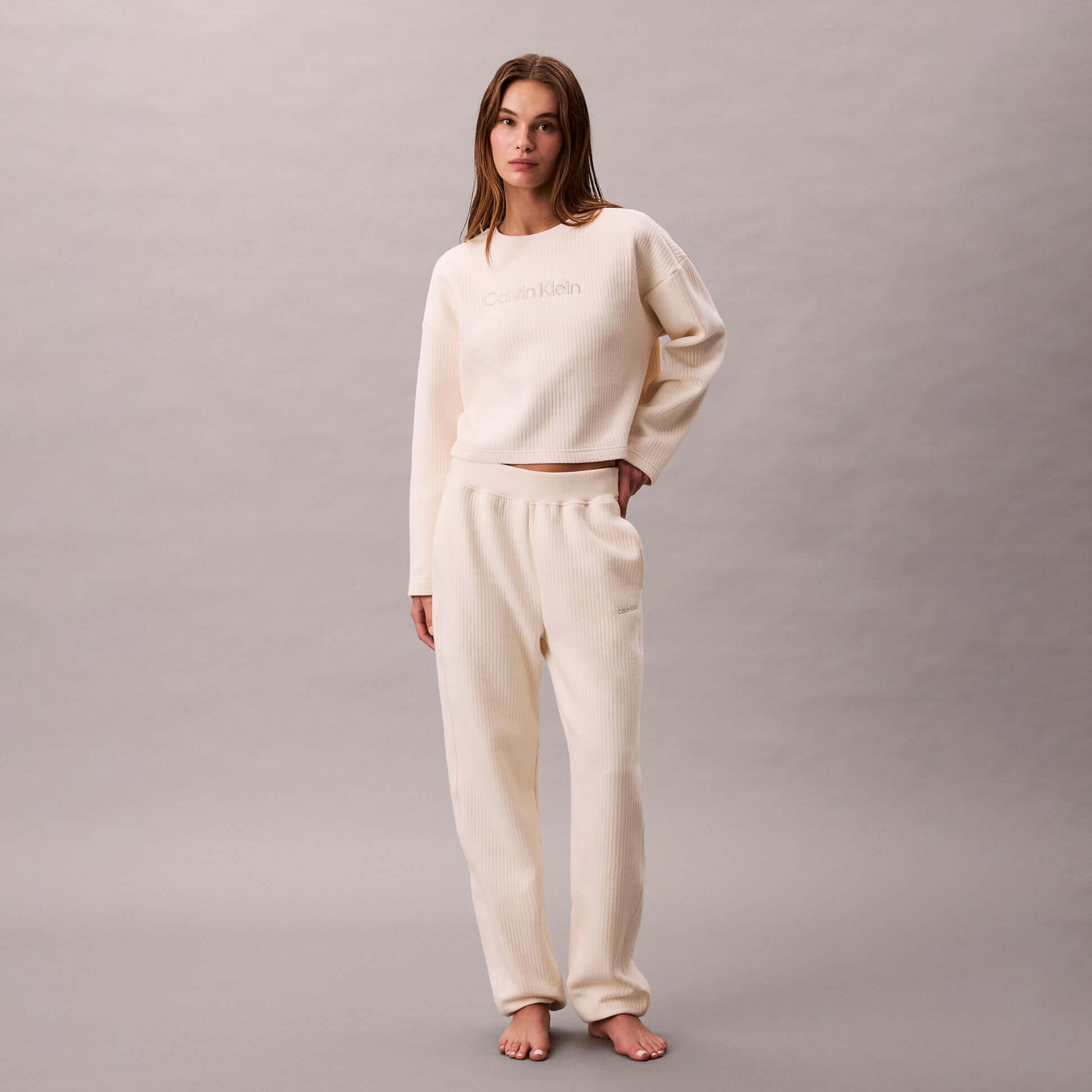 Calvin Klein LS QUILTED SWTSHIRT Womens Sweatshirts Ivory front view with model in matching sweatpants.