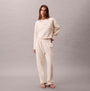 Calvin Klein LS QUILTED SWTSHIRT Womens Sweatshirts Ivory front view with model in matching sweatpants.