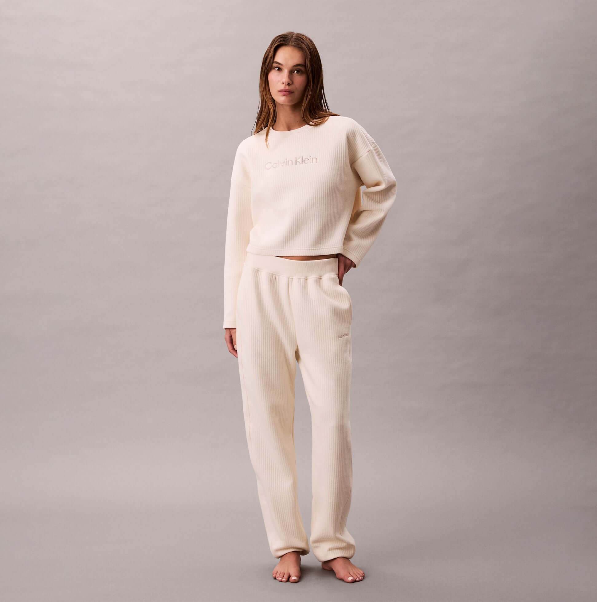 Calvin Klein LS QUILTED SWTSHIRT Womens Sweatshirts Ivory front view with model in matching sweatpants.