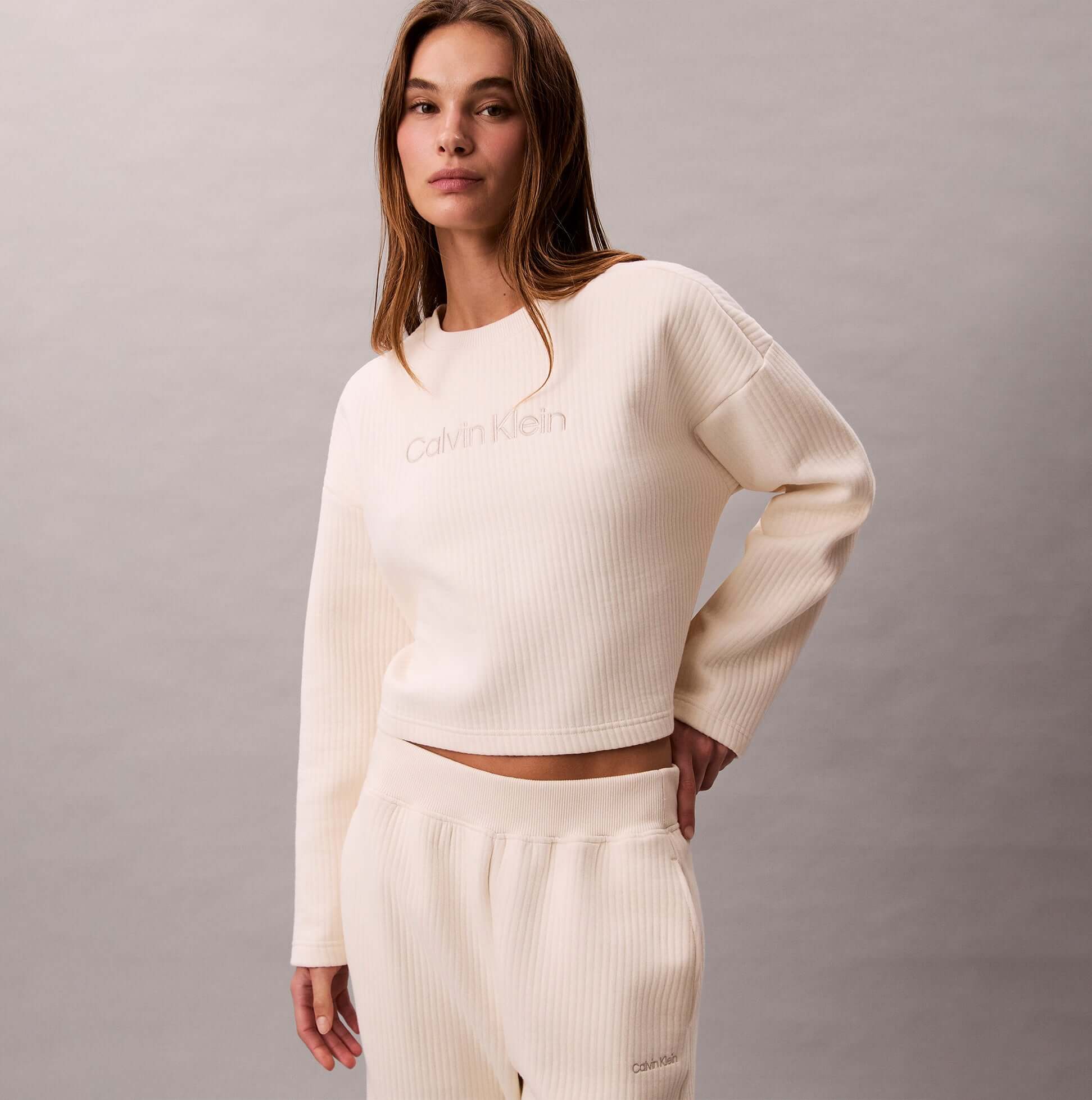 Calvin Klein LS QUILTED SWTSHIRT Womens Sweatshirts Ivory front view, featuring ribbed texture and relaxed fit.