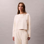 Calvin Klein LS QUILTED SWTSHIRT Womens Sweatshirts Ivory front view on model, featuring ribbed texture and logo.