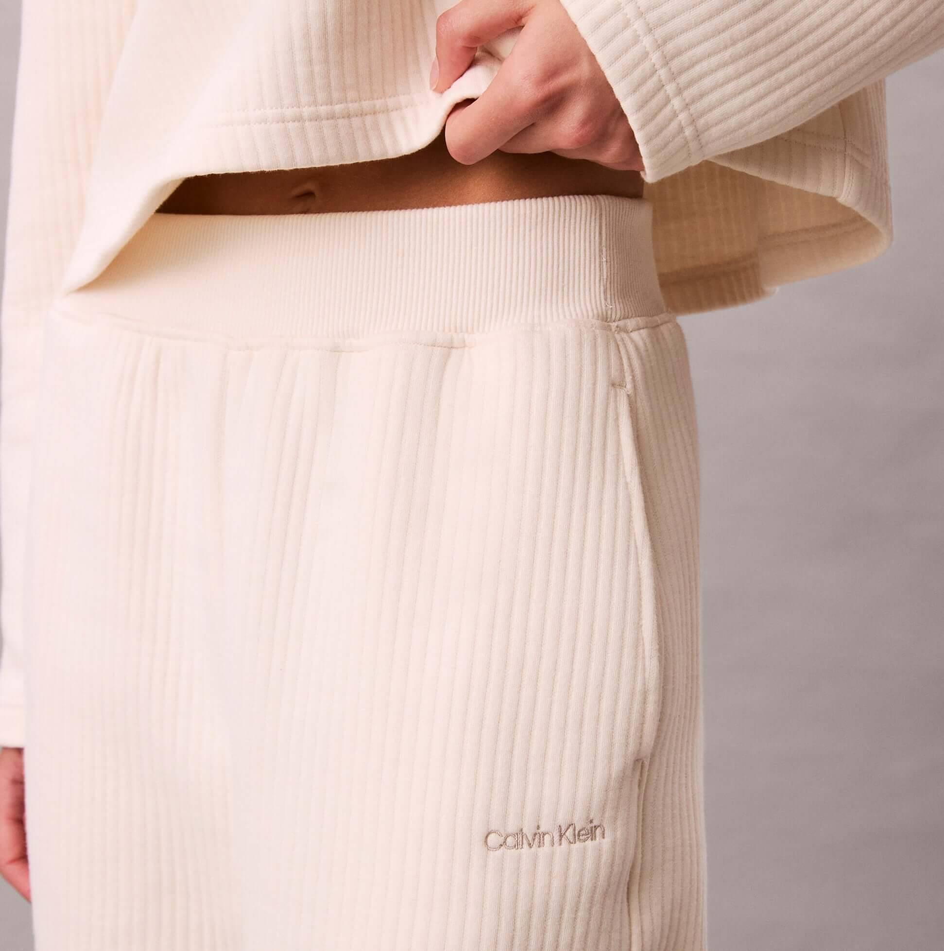 Calvin Klein QUILTED JOGGER Womens Ivory side view showing ribbed material and logo detailing.