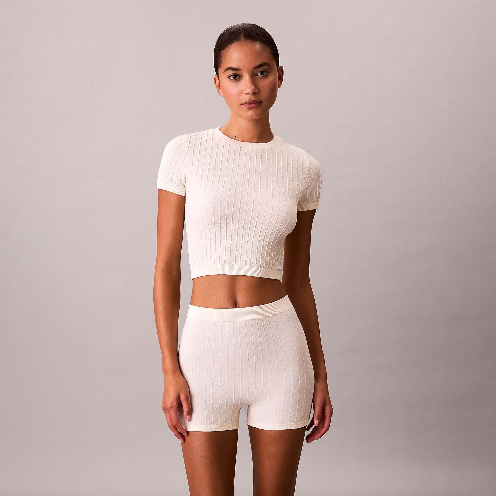 Calvin Klein SEAMLESS SHORTIE Womens Shorts Ivory front view model wearing set with cropped top and shorts.