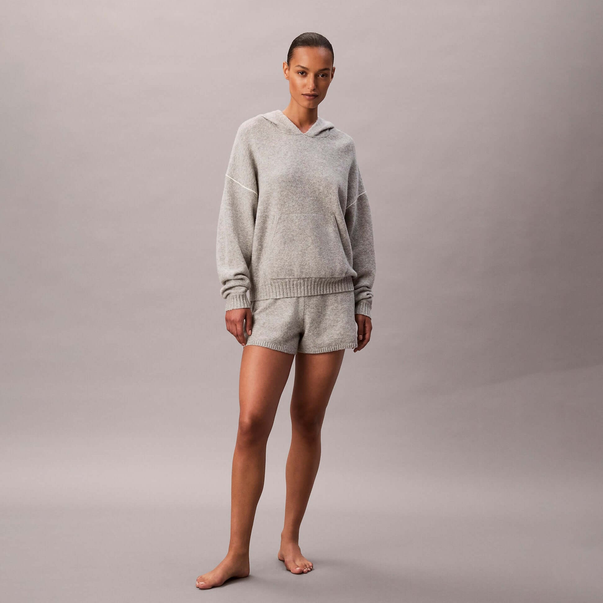 Calvin Klein PLUSH HOODIE. Womens Hoodies Grey Heather front view, styled with matching shorts in a soft blend of grey.