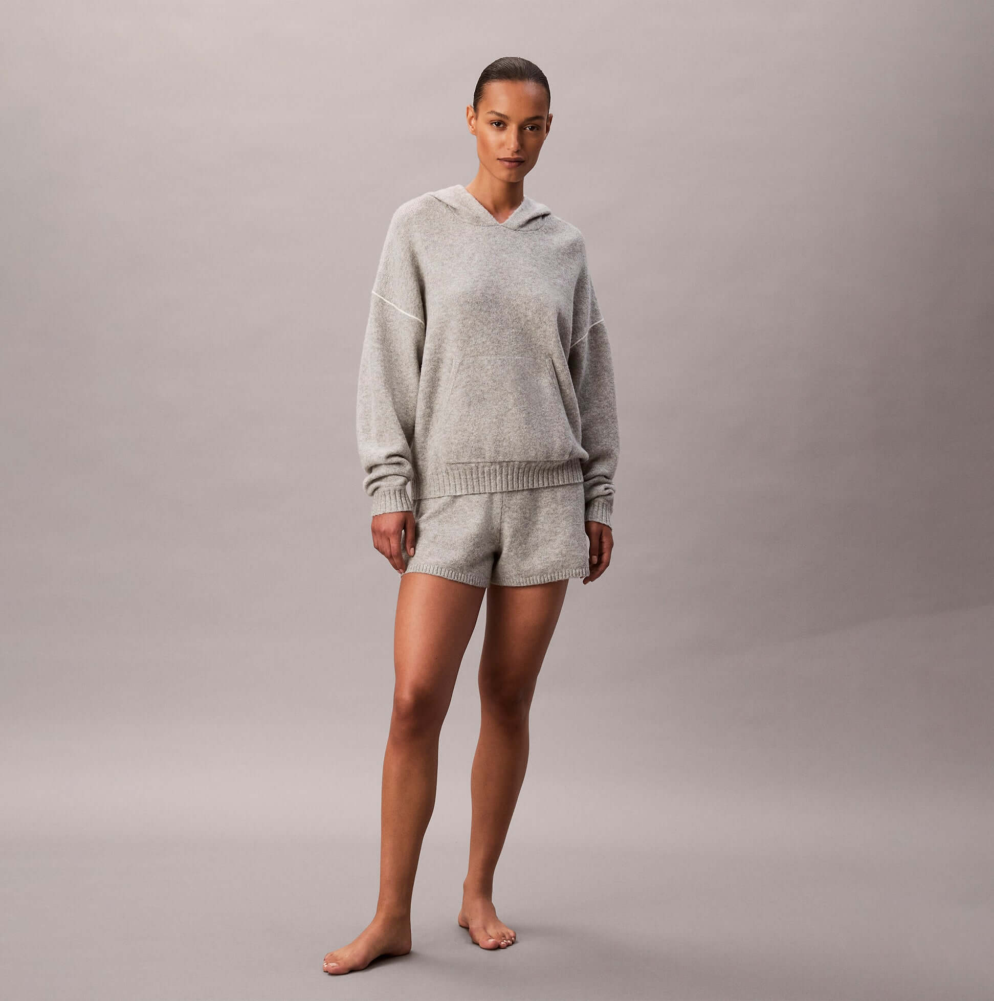 Calvin Klein PLUSH HOODIE. Womens Hoodies Grey Heather front view, styled with matching shorts in a soft blend of grey.