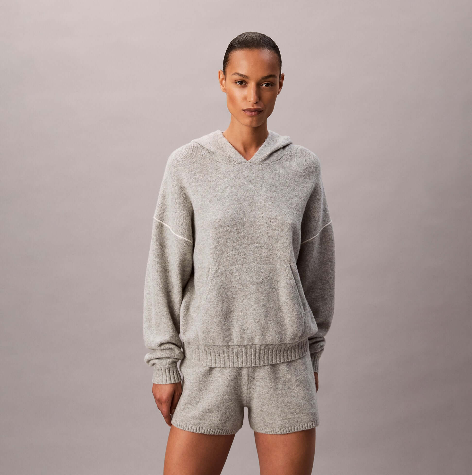 Calvin Klein PLUSH HOODIE. Womens Hoodies Grey Heather front view showcasing a stylish and cozy design.