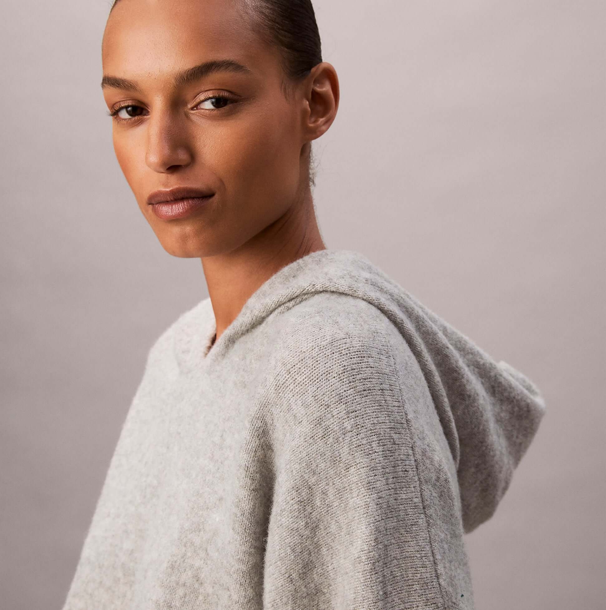 Calvin Klein PLUSH HOODIE. Womens Hoodies Grey Heather. Side view of model wearing soft grey hoodie.