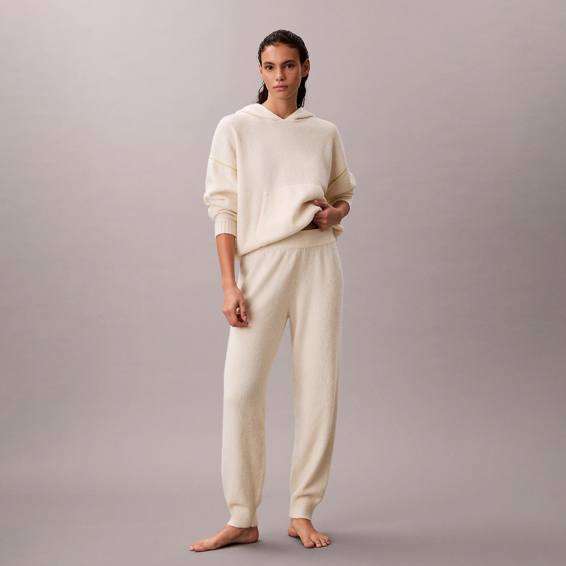 Calvin Klein PLUSH JOGGER. Womens Ivory. Front view of model wearing jogger set in soft ivory fabric.