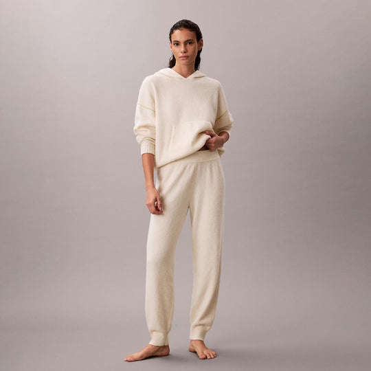 Calvin Klein PLUSH JOGGER. Womens Ivory. Front view of model wearing jogger set in soft ivory fabric.