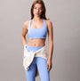 Calvin Klein Womens Quick-Dry Medium Impact Sports Bra Blue front view showcasing model with matching leggings.