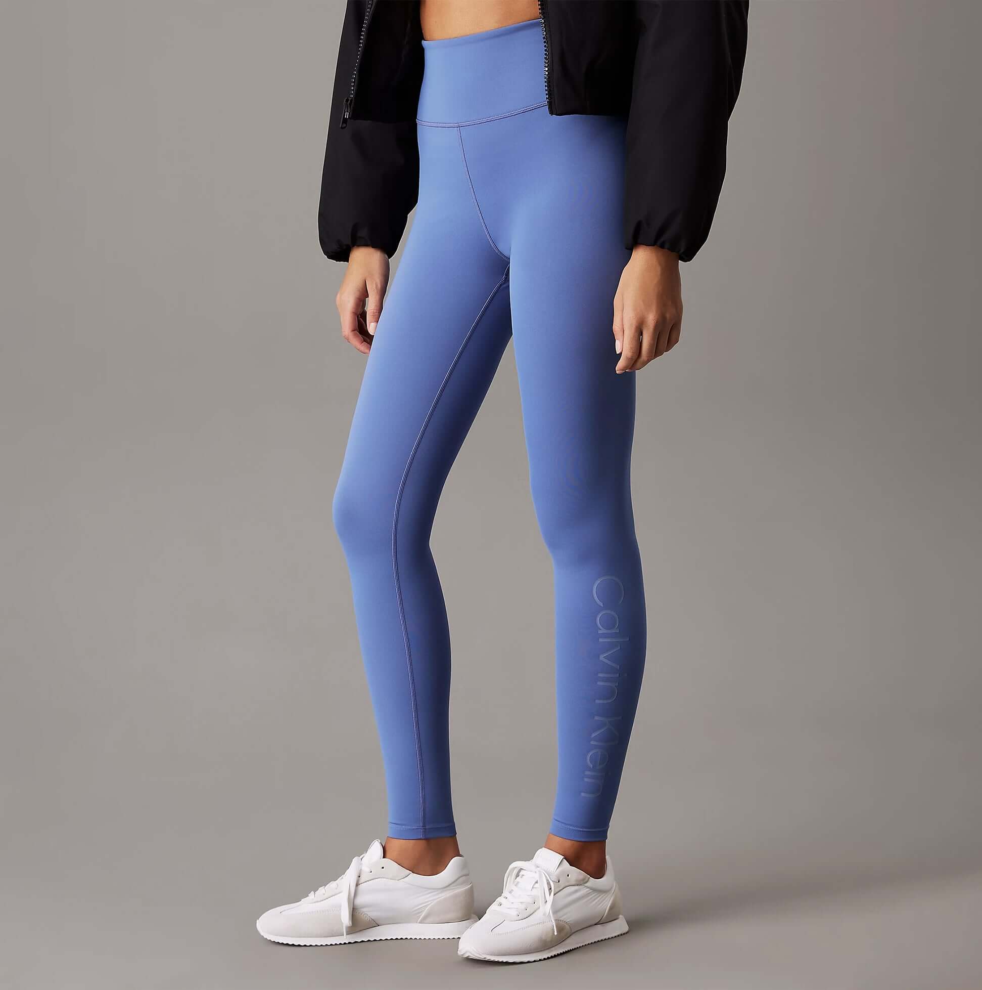 Calvin Klein LEGGING FULL Ladies Full Length Leggings Glacier side view in light blue with white sneakers.