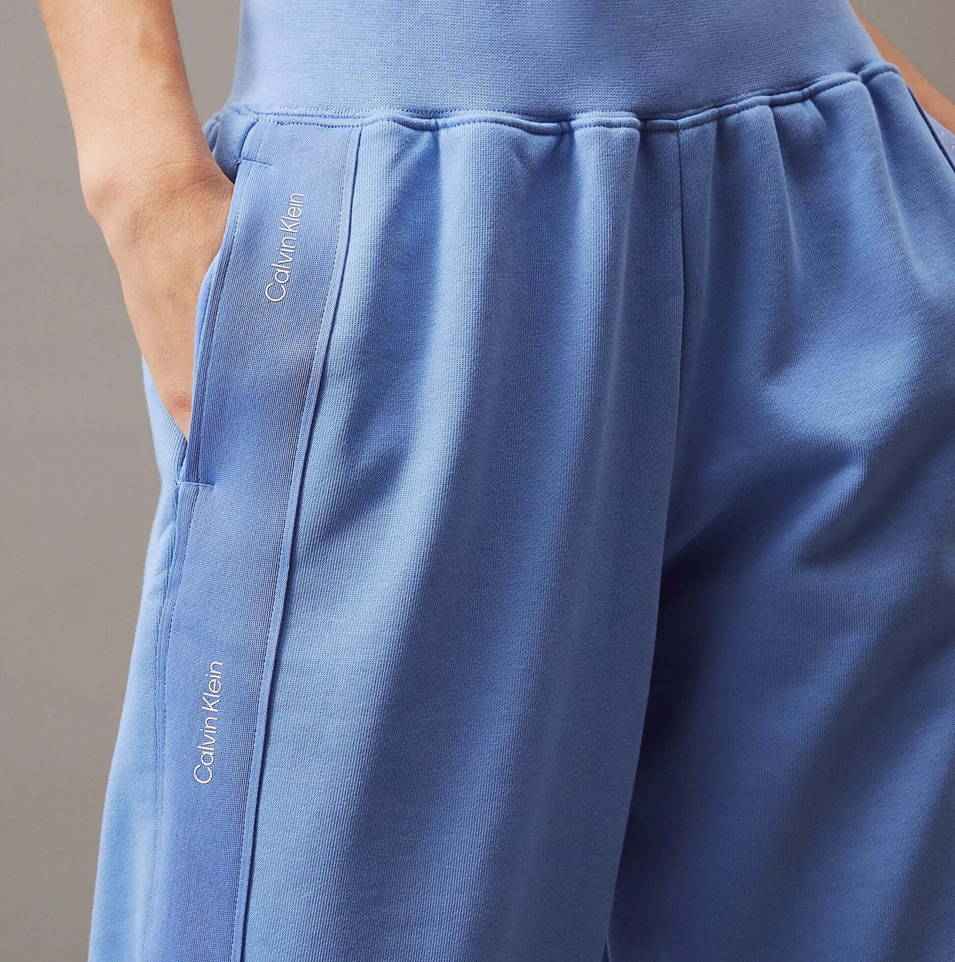 Calvin Klein JOGGER Womens Joggers Glacier detail view showcasing pockets and branding in soft blue fabric.