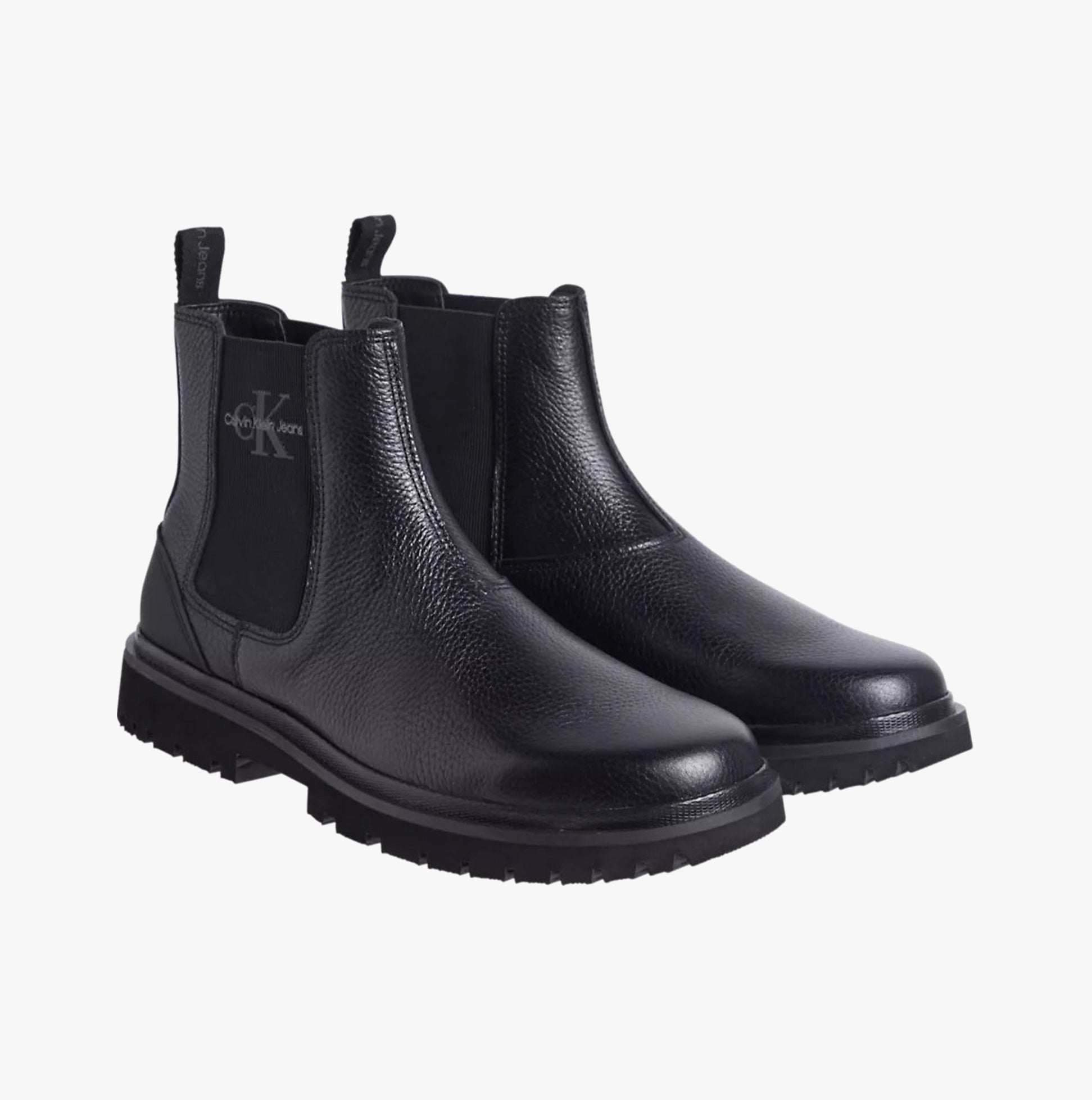 Calvin Klein EVA MID CHELSEA BOOTS Mens Triple Black side view showing leather upper and block heel.