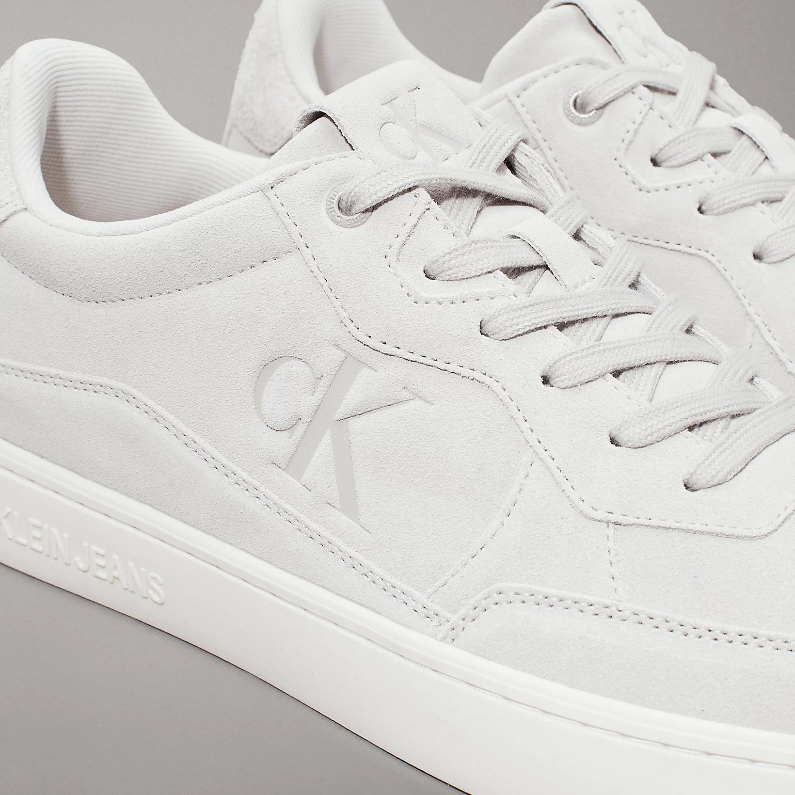 Calvin Klein CLASSIC CUPSOLE ICON Mens Trainers Eggshell/Creamy White close-up view highlighting nubuck and lace-up design.