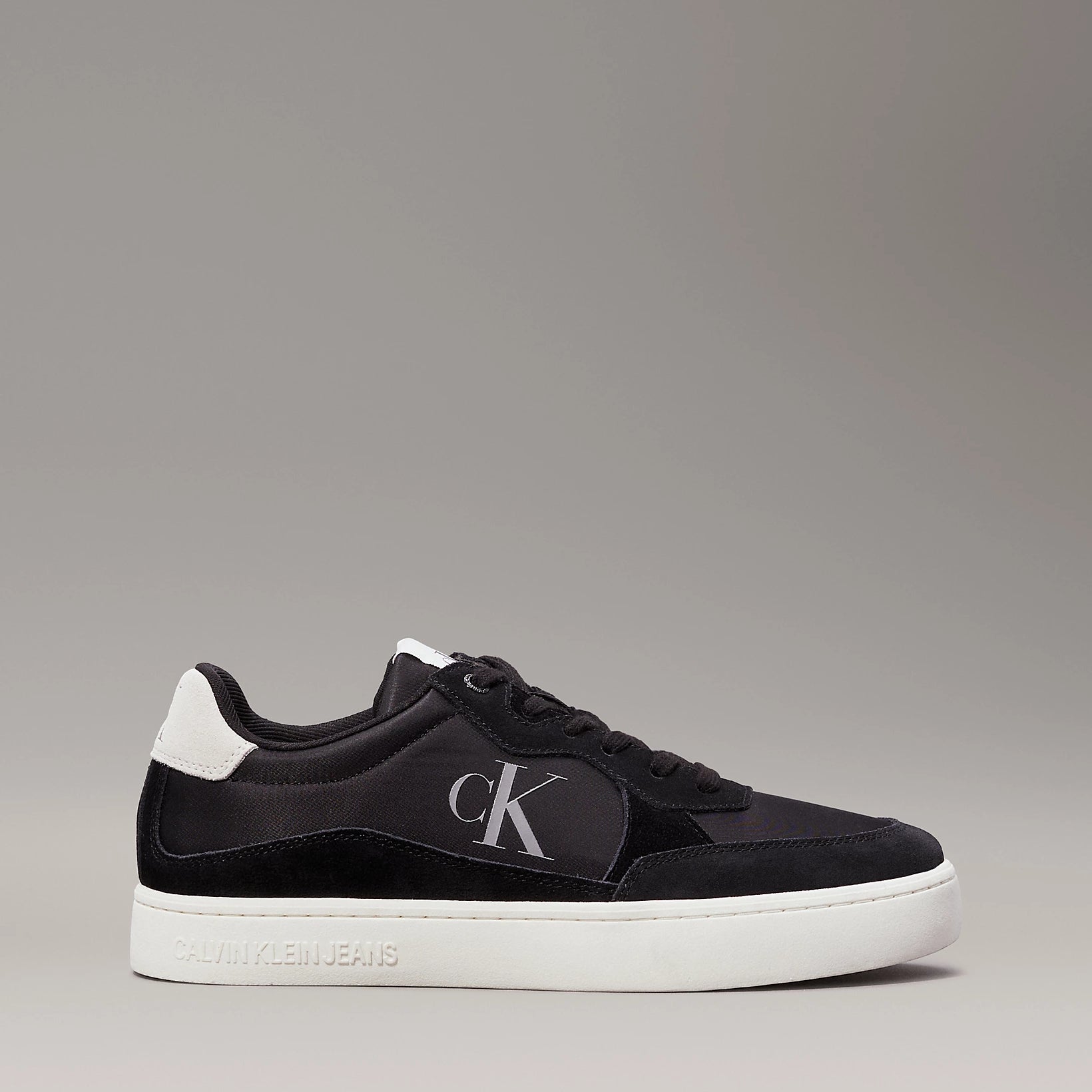 Calvin Klein CLASSIC CUPSOLE ICON Mens Trainers Black/Bright White, side view showcasing suede upper and lace-up design.