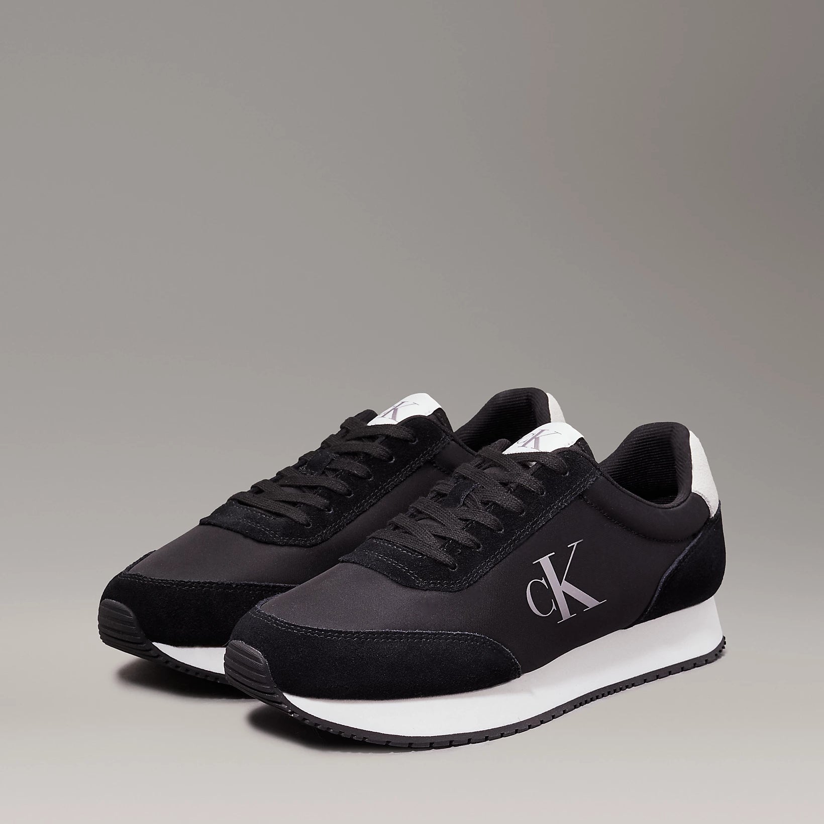 Calvin Klein RETRO RUNNER ICONIC Mens Trainers Black/Bright White side view showcasing suede and mesh materials.