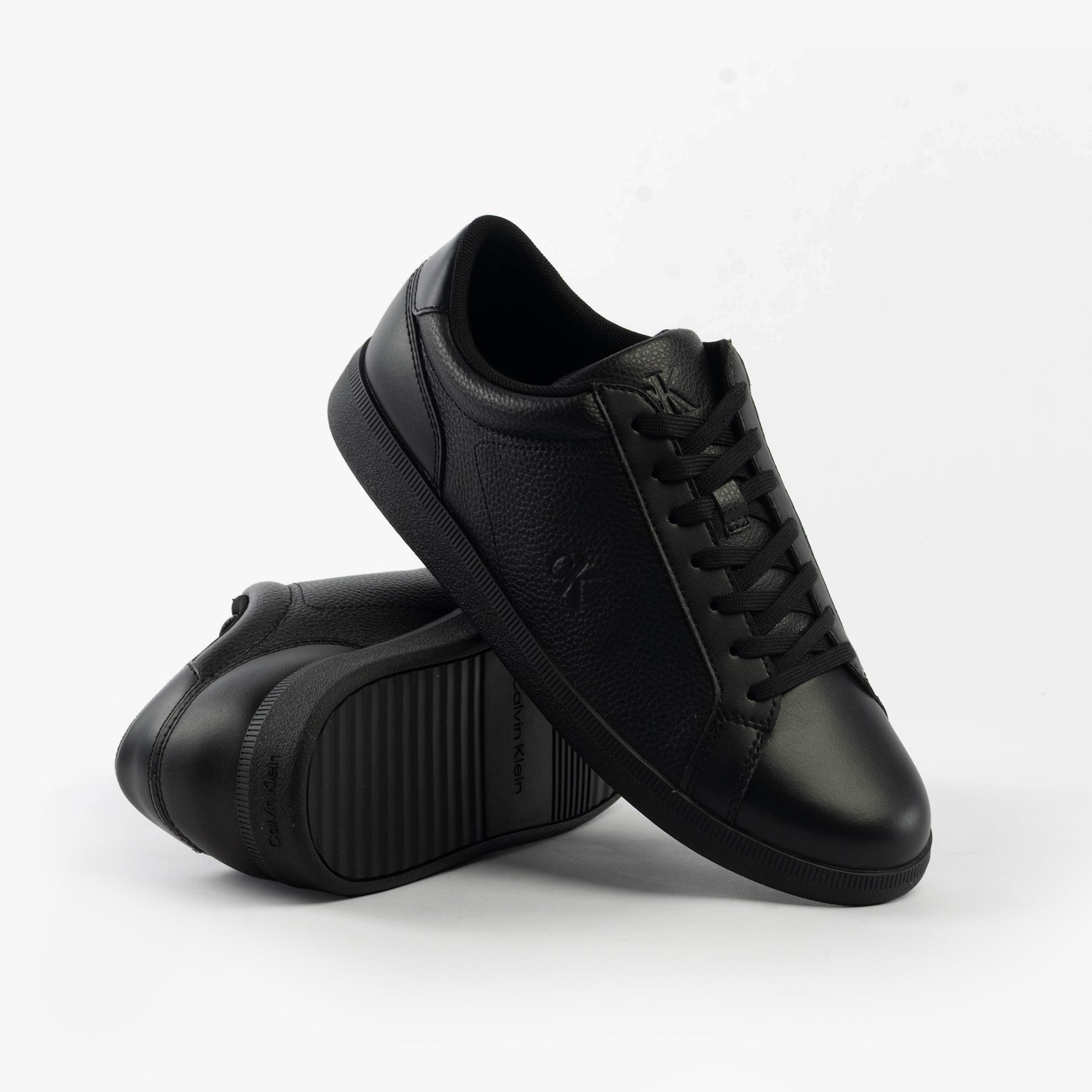 Calvin Klein LOW PROFILE CUPSOLE Mens Trainers Triple Black side view, showcasing leather upper and rubber sole.
