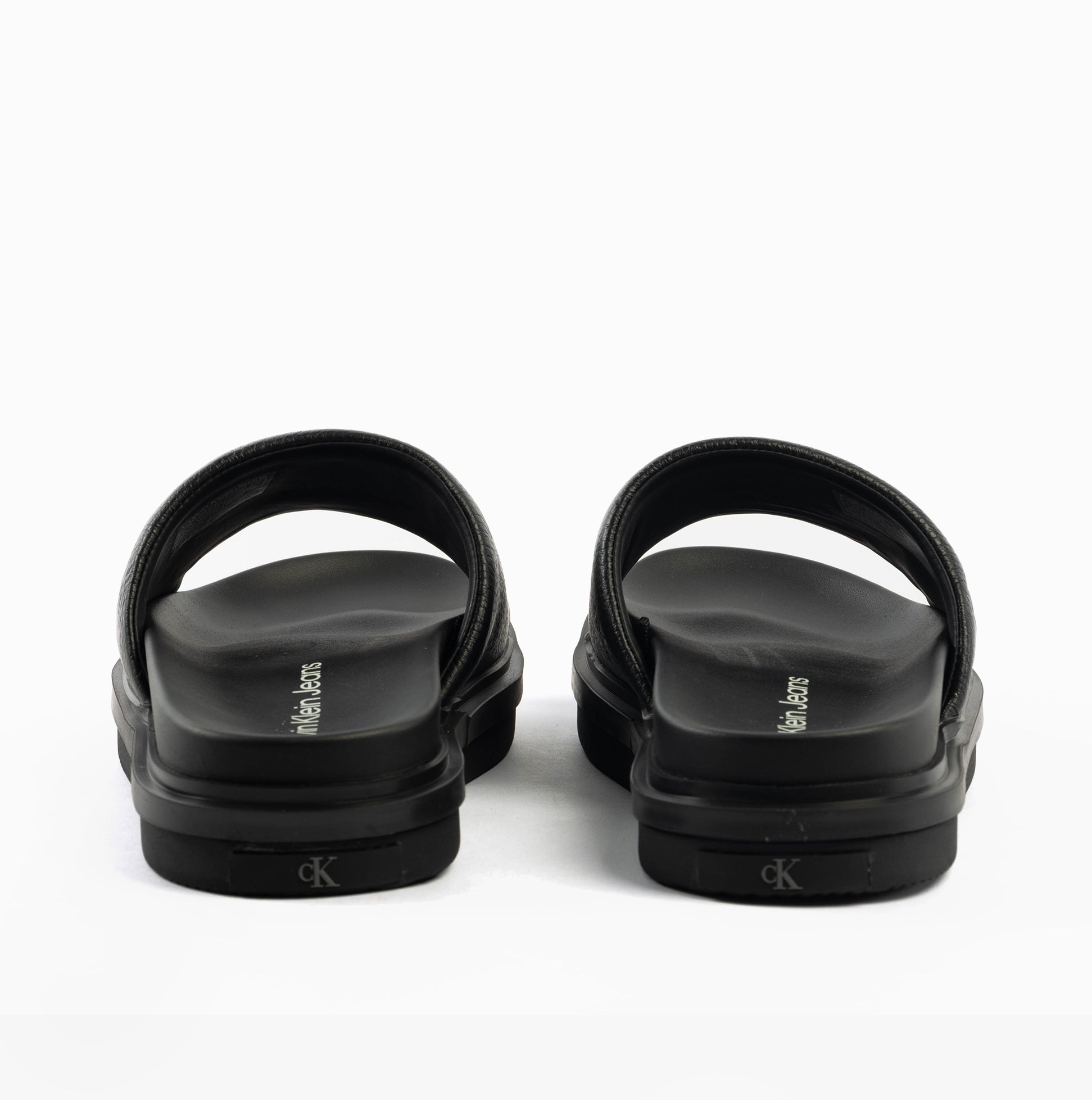 Calvin Klein FLAT MOLDED SLIDE Mens Triple Black rear view showing the lightweight slip-on design and leather upper.