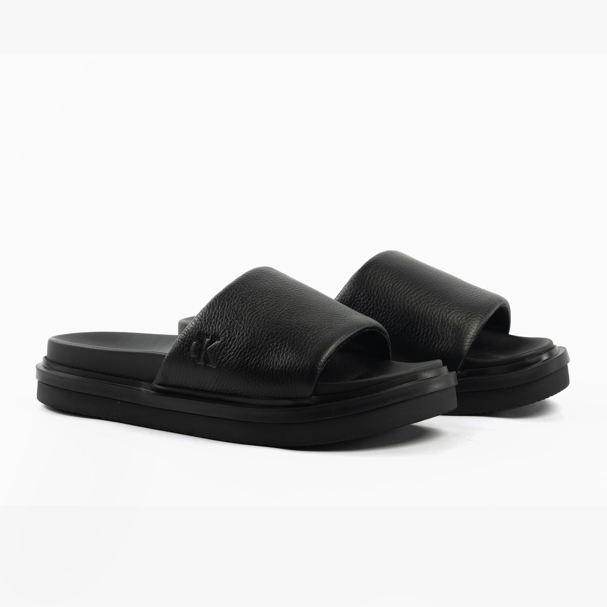 Calvin Klein FLAT MOLDED SLIDE Mens Triple Black side view showcasing leather upper and slip-on design.