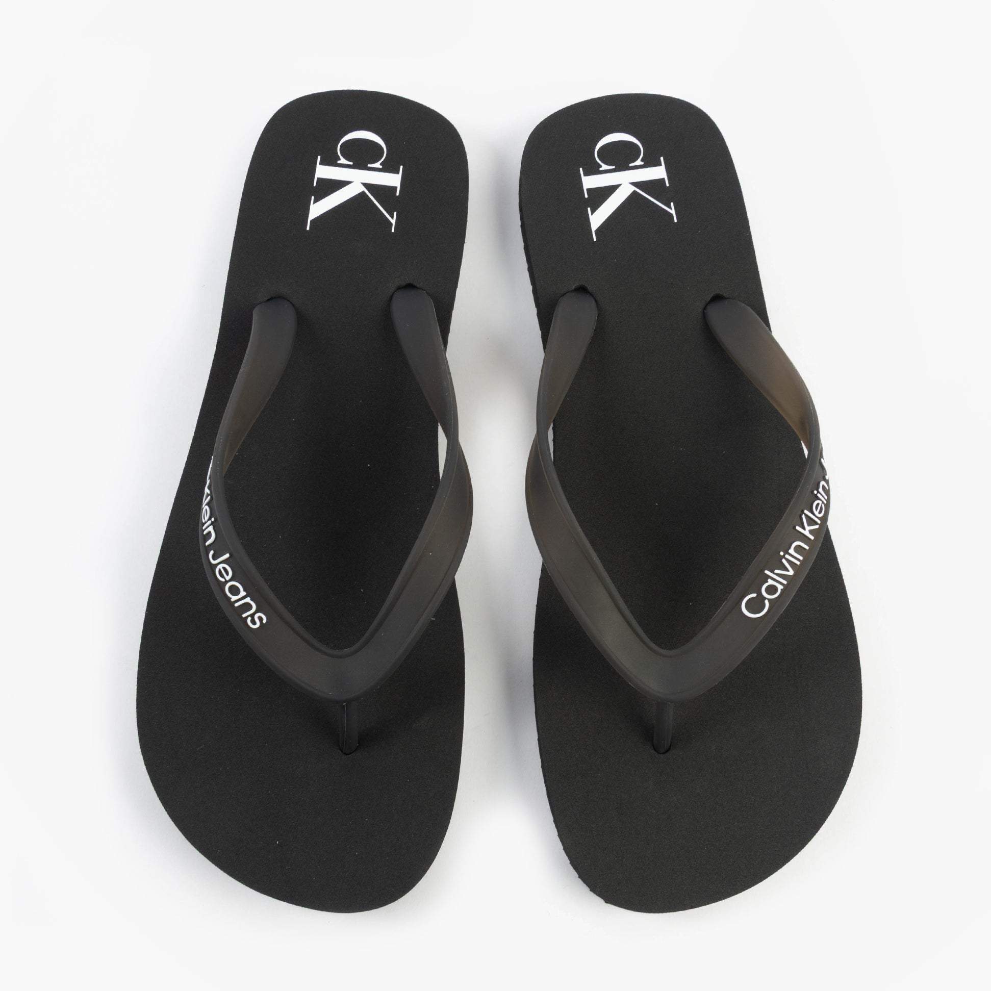 Calvin Klein BEACH SANDAL TRANSPA Mens Sandals Black/Bright White top view showcasing the stylish black design and logo.