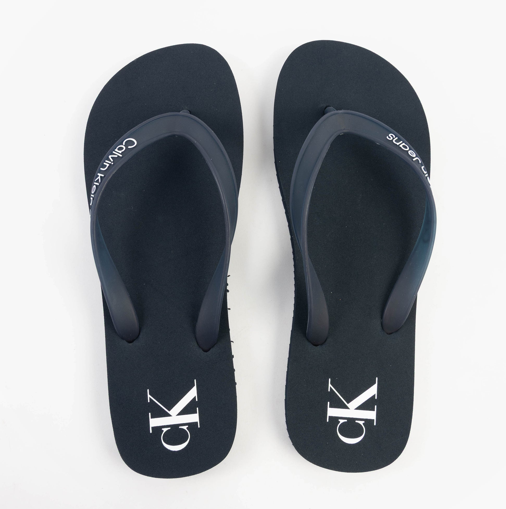 Calvin Klein BEACH SANDAL TRANSPA Mens Sandals Calvin Navy/Bright White top view showing navy sandals with white logo.